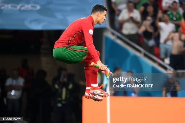 Portugal's forward Cristiano Ronaldo jumps prior to the UEFA EURO 2020 Group F football match between Portugal and France at Puskas Arena in Budapest...