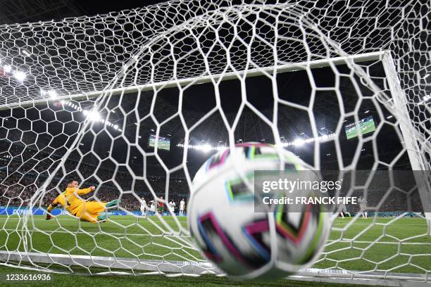 France's goalkeeper Hugo Lloris concedes the opening goal scored by Portugal's forward Cristiano Ronaldo from the penalty spot during the UEFA EURO...