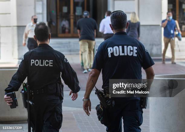 Members of the LAPD make their way towards City Hall in downtown Los Angeles.