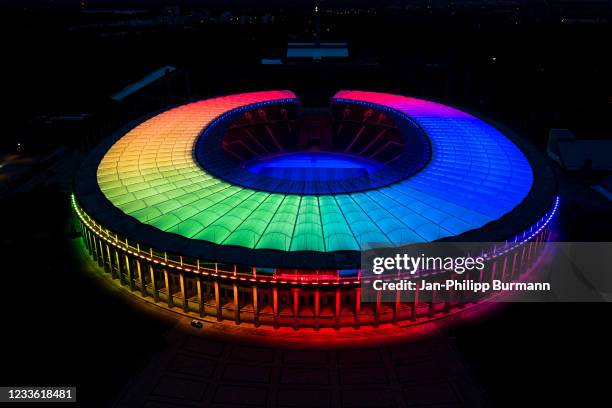 In this aerial view the Olympiastadion stadium stands illuminated in LGBT rainbow colors on June 23, 2021 in Berlin, Germany. Stadiums and landmarks...