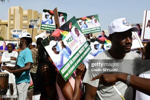 Supporters of Senegalese Democratic Party President Macky Sall react during a rally at Obelisque square in Dakar on June 23 to celebrate the tenth...