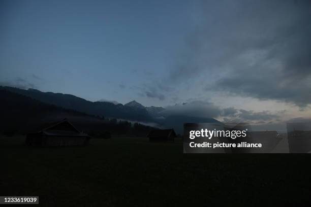 June 2021, Bavaria, Garmisch-Partenkirchen: The peaks are shrouded in clouds after heavy rain on the eve of St John's Day. Originally, it was...