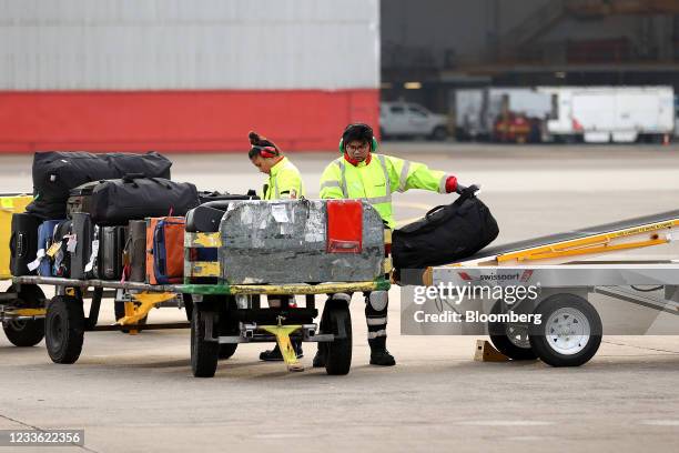 Members of the ground crew load luggage onto a passenger aircraft operated by Qantas Airways Ltd. At Sydney Airport in Sydney, Australia, on...