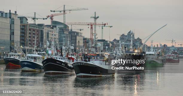 Flotilla of over 50 fishing boats leaving Dublin as they sail down the River Liffey this evening. Fishermen protested in Dublin today against a lack...