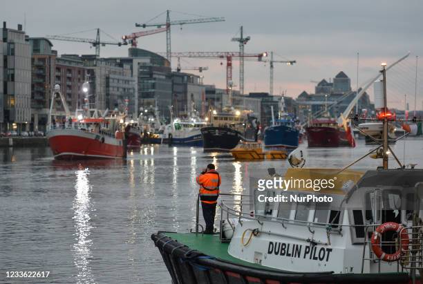 Flotilla of over 50 fishing boats leaving Dublin as they sail down the River Liffey this evening. Fishermen protested in Dublin today against a lack...
