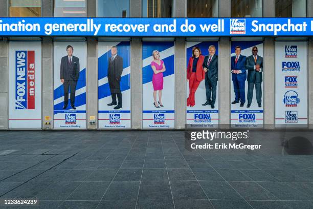 Giant portraits of the news anchors at Fox News headquarters building in New York City.