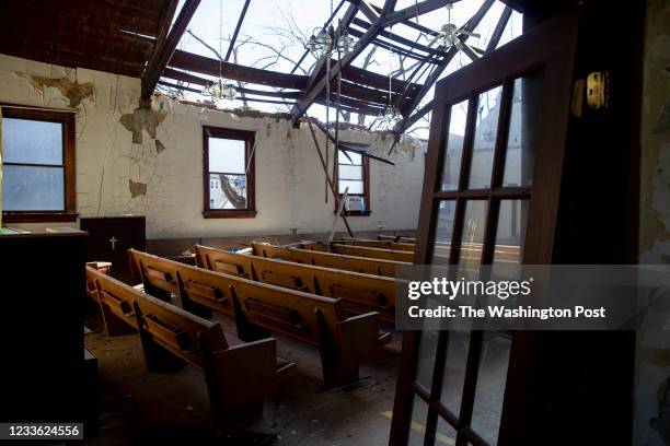 Pews sit in the sanctuary of Redemption Missionary Baptist Church after it was severely damaged during a derecho storm which brought 140 MPH winds...