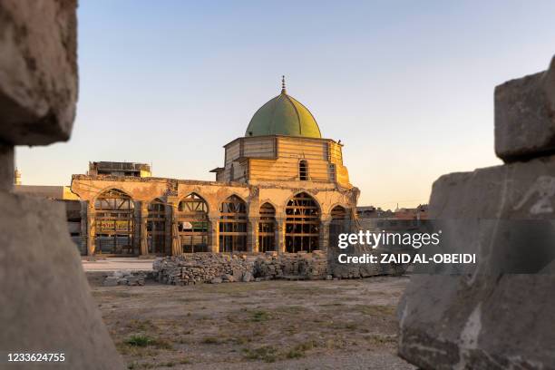 This picture taken late on June 23, 2021 shows a view of the dome of the Nuri mosque in the old town of Iraq's northern city Mosul, at the site...