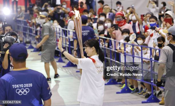 Barcelona Olympics 200-meter breaststroke gold medalist Kyoko Iwasaki runs in the Tokyo Olympic torch relay in the Shizuoka Prefecture city of...