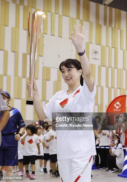 Barcelona Olympics 200-meter breaststroke gold medalist Kyoko Iwasaki runs in the Tokyo Olympic torch relay in the Shizuoka Prefecture city of...