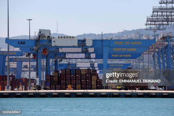 This picture shows countainer and cranes on a dock of the northern Israeli city of Haifa port, on June 24, 2021.
