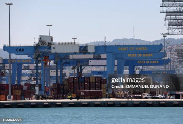 This picture shows countainer and cranes on a dock of the northern Israeli city of Haifa port, on June 24, 2021.
