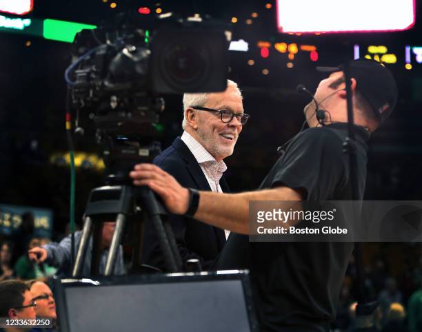 Boston, MA Boston Celtics television play by play announcer Mike Gorman is pictured as he has a laugh with a cameraman courtside before he does the...