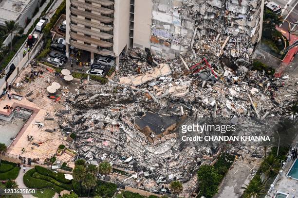 This aerial view, shows search and rescue personnel working on site after the partial collapse of the Champlain Towers South in Surfside, north of...