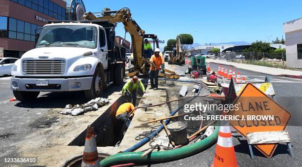 Roadworks crew work in Monterey Park, California on June 24, 2021. - US President Joe Biden on Thursday announced that a deal has been reached with a...
