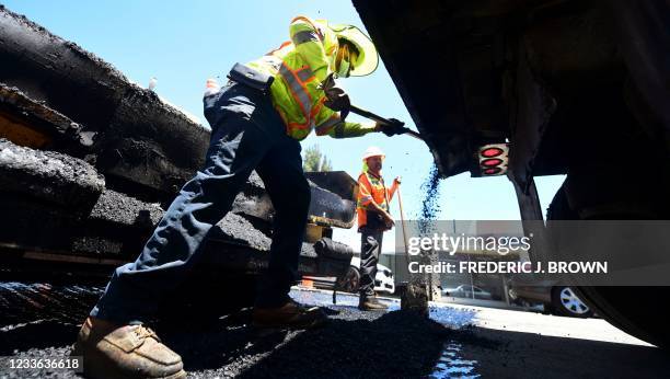 Roadworks crew work on road resurfacing on June 24, 2021 in Alhambra, California. - US President Joe Biden on Thursday announced that a deal has been...