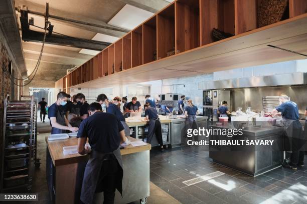 Personnel of the World class Danish restaurant Noma works in the kichten on May 31, 2021 in Copenhagen. - While the six-month Covid-19 closure has...