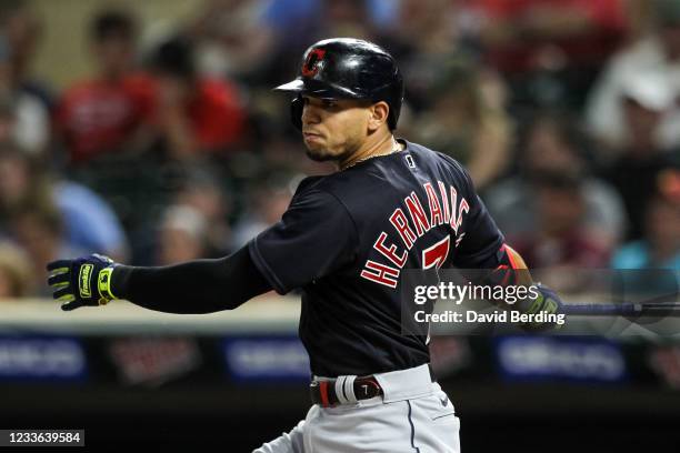 Cesar Hernandez of the Cleveland Indians hits a single against the Minnesota Twins in the eighth inning at Target Field on June 24, 2021 in...