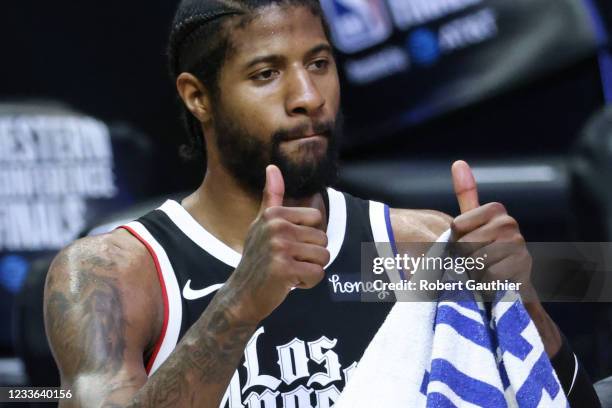 Thursday, June 24 Los Angeles CA - LA Clippers guard Paul George flashes the thumbs up sign to fans after beating the Phoenix Suns in Game three of...