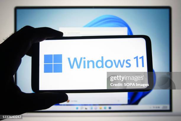 In this photo illustration a Windows 11 logo is seen on a smartphone screen with a Microsoft website in the background. Microsoft has presented...