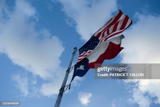 The United States Flag and Texas State Flag are displayed at Murchison Rogers Park along Scenic Drive at sunset on June 24, 2021 in El Paso, Texas.