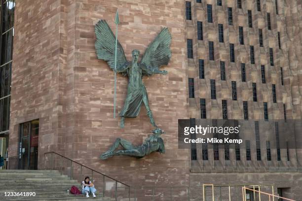 Victory over the Devil, a sculpture by Jacob Epstein outside Coventry Cathedral with St Michael's also known as St Michael's, a modern cathedral...