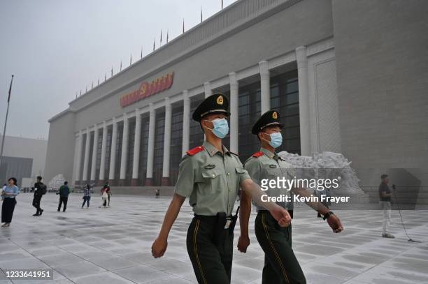 Chinese police officers walk outside the newly built Museum of the Communist Party of China on June 25, 2021 in Beijing, China. China will mark the...