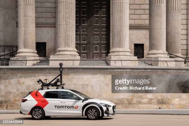 Car equipped with camera and mapping technology for the SatNav brand TomTom drives beneath the pillars and column architecture of Sir Christopher...