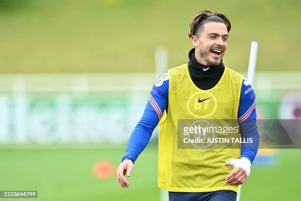 England's midfielder Jack Grealish laughs during a training session at St George's Park in Burton-on-Trent on June 25, 2021 as part of the UEFA EURO...