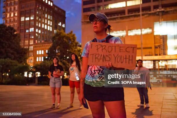 Brittany McClaskey of Westerville holds a sign advocating for trans youth in front of the Ohio Statehouse to protest against legislation banning of...