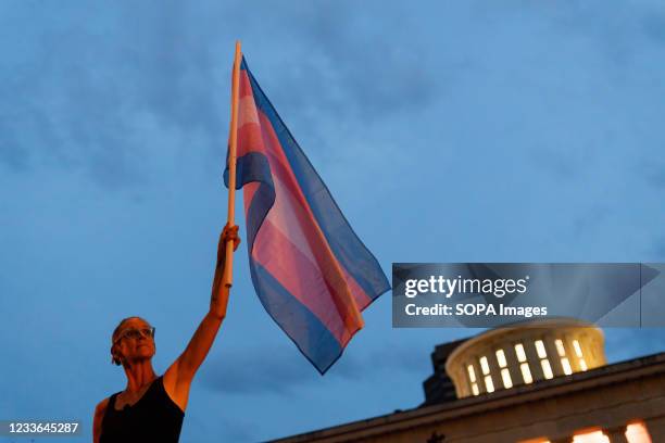 Cole Ramsey of South Linden holds a Transgender Pride Flag in front of the Ohio Statehouse to protest the passing of legislation against Trans Women...