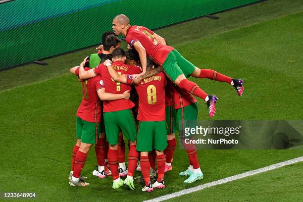 Portugal's forward Cristiano Ronaldo celebrates with teammates Pepe, Renato Sanchez and others after scoring the opening goal from the penalty spot...