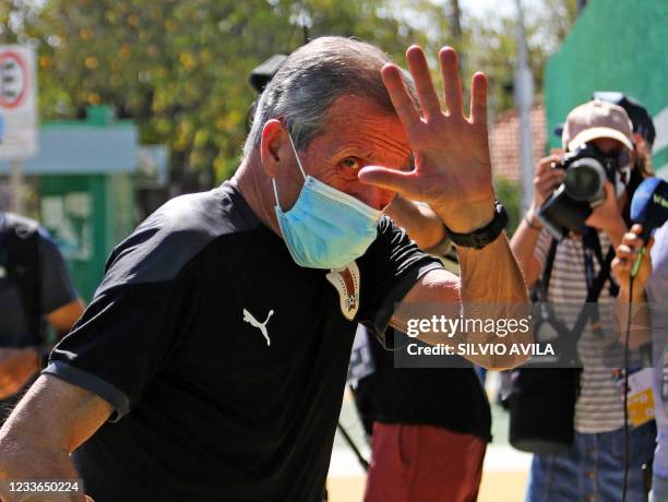 Uruguay's national football team head coach Oscar Washington Tabarez waves as he arrives at a training session at the Eurico Gaspar Dutra Stadium, in...