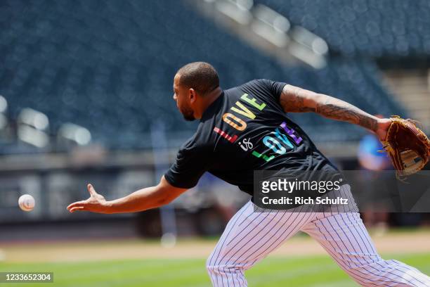Dominic Smith of the New York Mets warms up with a Love is Love shirt in honor of Pride Night before game one of a doubleheader against the...