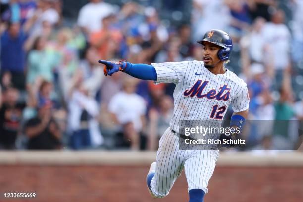 Francisco Lindor of the New York Mets gestures to his teammates after he hit an RBI single in the seventh inning to tie the score against the...