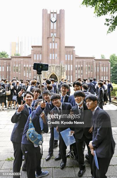 University of Tokyo students pose for a photo before attending a welcoming ceremony held at the Hongo campus in Tokyo on June 26 for students who...