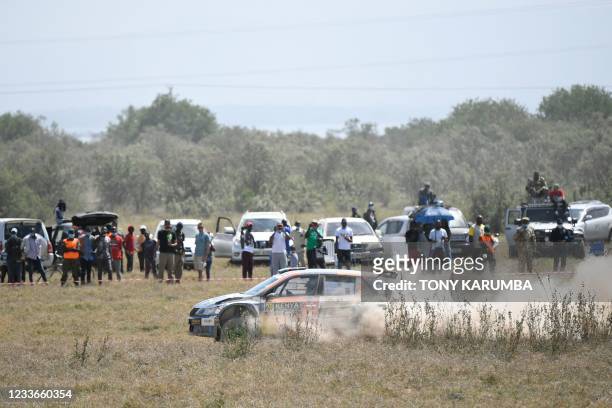 Kenyan driver Aakif Virani steers his Skoda Fabia with Kenyan co-driver Azhar Bhatti as spectators look on during the SS10 stage of the 2021 Safari...