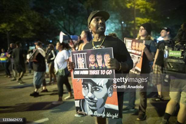 Protesters stand near the Hennepin County Government Center to raise awareness to the other 3 officers that are going to trial in the killing of...