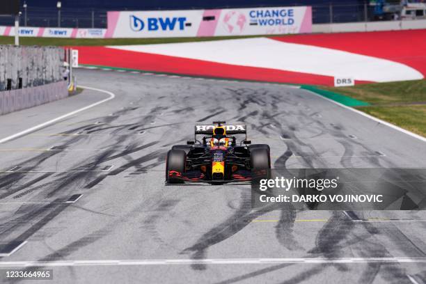 Red Bull's Dutch driver Max Verstappen crosses the finish line to take the first place and claim the pole position after the qualifying session at...
