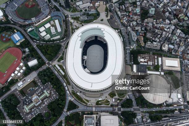The Tokyo Olympic Stadium and Tokyo Metropolitan Gymnasium are pictured from a helicopter on June 26, 2021 in Tokyo, Japan. With less than one month...