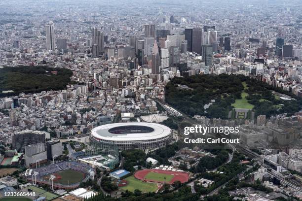 The Tokyo Olympic Stadium and Shinjuku skyline are pictured from a helicopter on June 26, 2021 in Tokyo, Japan. With less than one month to go before...