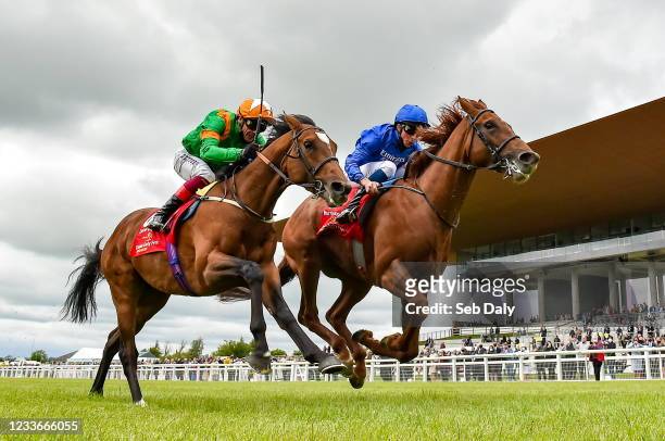 Kildare , Ireland - 26 June 2021; Hurricane Lane, right, with William Buick up, on their way to winning the Dubai Duty Free Irish Derby, from second...