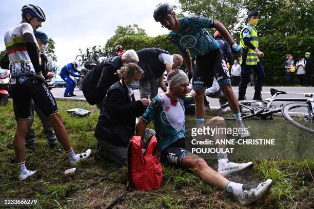 Team B&B KTM's Cyril Lemoine of France is helped by medical staff members after crashing during the 1st stage of the 108th edition of the Tour de...