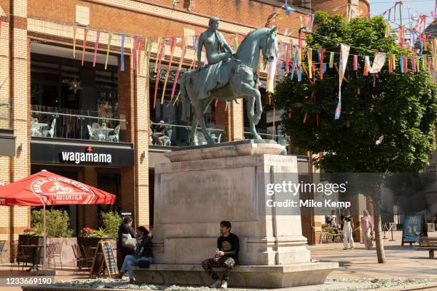 Godiva statue underneath colourful bunting hanging in Broadgate in the UK City of Culture 2021 on 23rd June 2021 in Coventry, United Kingdom. The...