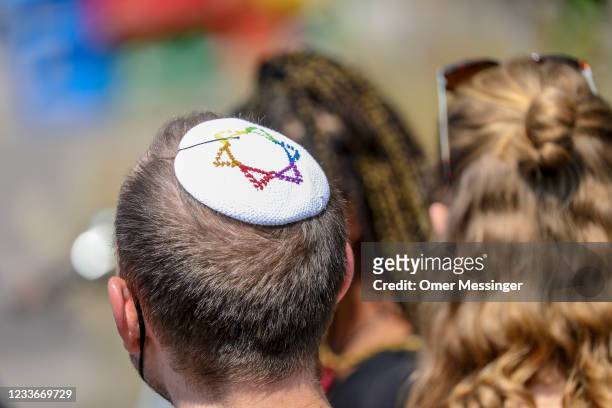 Participant wears a Kippa with a rainbow colored star of david as participants in the Queerschutz Now! march in commemoration and celebration of...