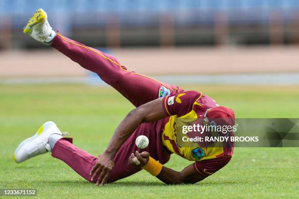 Dwayne Bravo of West Indies stops the ball from going to the boundary during the 1st T20I between West Indies and South Africa at Grenada National...