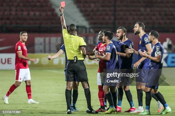 Cameroonian referee Alliom Nyant issues a red card to Esperance's defender Ilyes Chetti during the second leg of the CAF champions league semi-final...