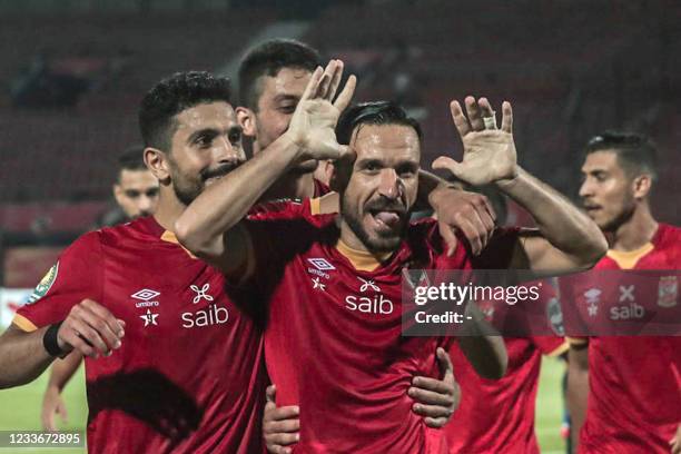 Ahly's defender Ali Maaloul celebrates with his teammates after scoring from a penalty kick during the second leg of the CAF champions league...