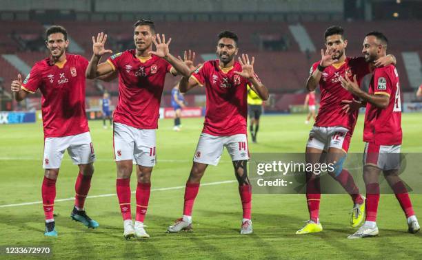 Ahly's players show the number "10" with their hands as they celebrate after winning the second leg of the CAF champions league semi-final football...