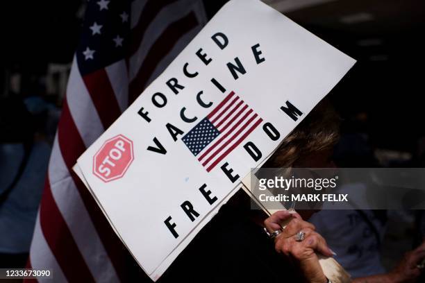 Anti-vaccine rally protesters hold signs outside of Houston Methodist Hospital in Houston, Texas, on June 26, 2021. - A spokesperson for Houston...